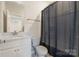 Well-lit bathroom with modern fixtures, including a vanity sink and toilet with privacy curtain at 355 S Bruns Ave, Charlotte, NC 28208