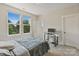 A well-lit bedroom with two windows offering scenic views and a workstation for work or study at 355 S Bruns Ave, Charlotte, NC 28208