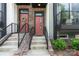 Close-up of two townhome entryways, each featuring a painted front door, stairs and decorative accents at 355 S Bruns Ave, Charlotte, NC 28208