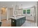 Spacious kitchen island with bar stool seating, white countertops, and ample cabinet space at 355 S Bruns Ave, Charlotte, NC 28208
