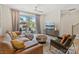 Inviting living room with a large window to a balcony, a leather sectional, and stylish furnishings at 355 S Bruns Ave, Charlotte, NC 28208