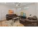 Inviting living room features a ceiling fan, stylish decor, and a comfortable leather sofa at 355 S Bruns Ave, Charlotte, NC 28208