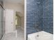 Luxurious bathroom showcasing a blue-tiled shower, separate soaking tub, and bright, airy design at 4006 Scarlet Dr # 29, Matthews, NC 28104