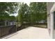 Newly constructed deck with dark railing overlooking a yard with mature trees at 4006 Scarlet Dr # 29, Matthews, NC 28104