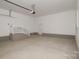Spacious garage with ample room for parking and storage, featuring a staircase and neutral finishes at 4006 Scarlet Dr # 29, Matthews, NC 28104