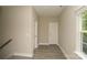 Upstairs hallway with neutral walls, a window, and two doors at 4006 Scarlet Dr # 29, Matthews, NC 28104
