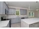 Modern kitchen featuring grey cabinets, stainless steel appliances, stylish backsplash, and white countertops at 4006 Scarlet Dr # 29, Matthews, NC 28104