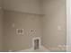 Laundry room featuring white shelving, neutral paint, and a utility sink at 4006 Scarlet Dr # 29, Matthews, NC 28104
