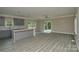 Open concept living room with gray floors and sliding glass doors to the exterior at 4006 Scarlet Dr # 29, Matthews, NC 28104