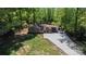 Aerial view of a home with a large driveway and surrounded by lush greenery at 403 3Rd Nw St, Conover, NC 28613