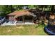 Aerial view of a backyard with a covered patio, furniture, a boat and trampoline at 403 3Rd Nw St, Conover, NC 28613