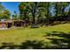 Expansive backyard features lush lawn, mature trees, and a trampoline at 403 3Rd Nw St, Conover, NC 28613