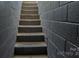 Concrete stairs lead to the basement surrounded by gray cinder block walls at 403 3Rd Nw St, Conover, NC 28613
