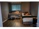 Cozy bedroom with vinyl floors, a piano, and a comfortable bed by the window at 403 3Rd Nw St, Conover, NC 28613