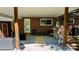 Brick home's covered patio with furniture, gas grill, and concrete flooring at 403 3Rd Nw St, Conover, NC 28613