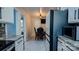Bright kitchen showcasing granite countertops, white cabinets, and stainless steel refrigerator at 403 3Rd Nw St, Conover, NC 28613