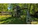 Well-maintained wooden playground with slide, ladder, swings, and a small hut at 403 3Rd Nw St, Conover, NC 28613