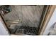This bathroom features a shower with marble style tile and a unique black and white mosaic floor at 403 3Rd Nw St, Conover, NC 28613