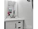 Modern half bath showcases white vanity, black hardware, and stylish mirror at 4148 Shasta Cir, Clover, SC 29710