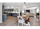 Open dining area with modern lighting, wooden table and benches, with view to the living room at 4148 Shasta Cir, Clover, SC 29710