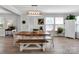 Bright dining area features a wooden table with bench seating and a modern light fixture at 4148 Shasta Cir, Clover, SC 29710