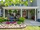 Cozy front porch with hanging ferns, wicker chairs, and a beautiful rock garden at 4148 Shasta Cir, Clover, SC 29710