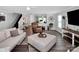 Living room with wood floors, neutral sectional sofa, recliner, and view to the backyard at 4148 Shasta Cir, Clover, SC 29710