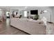 Open living room with wood floors, large sectional sofa and access to other rooms at 4148 Shasta Cir, Clover, SC 29710