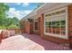 Inviting back deck with red wood flooring and brick house exterior at 4232 Shannamara Dr, Matthews, NC 28104