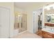Bathroom with shower, vanity, and an open doorway leading to a closet at 4232 Shannamara Dr, Matthews, NC 28104