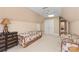 Cozy bedroom with neutral walls, ceiling fan, skylight, and sitting area at 4232 Shannamara Dr, Matthews, NC 28104
