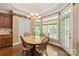 Bright breakfast nook with wood floors, a round table, and large windows at 4232 Shannamara Dr, Matthews, NC 28104