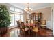 Formal dining room features hardwood floors, elegant decor, and natural light at 4232 Shannamara Dr, Matthews, NC 28104
