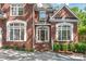 Inviting entryway with brick steps, manicured shrubs and white-framed windows at 4232 Shannamara Dr, Matthews, NC 28104