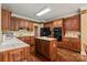 Functional kitchen features wooden cabinets, a center island, and black appliances at 4232 Shannamara Dr, Matthews, NC 28104