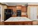 Traditional kitchen with wooden cabinets, island, and black appliances at 4232 Shannamara Dr, Matthews, NC 28104