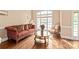 Cozy living room with hardwood floors, elegant furniture, and a large window at 4232 Shannamara Dr, Matthews, NC 28104