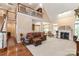 Open living room with fireplace, high ceilings, and a view of the upper level at 4232 Shannamara Dr, Matthews, NC 28104