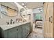 A well-lit bathroom featuring dual sinks, granite countertop, and views into the bedroom at 425 W North Corner Rd, Lancaster, SC 29720
