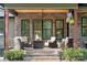 Charming covered patio featuring comfortable seating, a stone fireplace, and scenic views at 425 W North Corner Rd, Lancaster, SC 29720