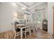Bright dining room with wood floors, large windows and modern chandelier lighting at 425 W North Corner Rd, Lancaster, SC 29720