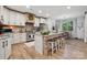 Well-lit kitchen with white cabinets, granite countertops, a large island, and modern appliances at 425 W North Corner Rd, Lancaster, SC 29720