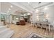 Open-concept living and dining area features a stone fireplace, wood floors, and coffered ceilings at 425 W North Corner Rd, Lancaster, SC 29720