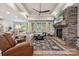 Bright and airy living room with stone fireplace, wood floors, and natural lighting at 425 W North Corner Rd, Lancaster, SC 29720