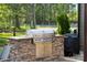 State-of-the-art outdoor kitchen with a built-in grill and stone countertop at 425 W North Corner Rd, Lancaster, SC 29720