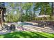 Beautiful backyard pool area with ample seating and a well-manicured lawn, perfect for entertaining at 425 W North Corner Rd, Lancaster, SC 29720