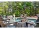 Tranquil backyard pool setting with a fire pit, lounge chairs, and serene forest views at 425 W North Corner Rd, Lancaster, SC 29720