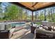 Tranquil outdoor space with pool, covered patio, built-in grill, and comfortable seating at 425 W North Corner Rd, Lancaster, SC 29720