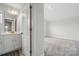 Bathroom and a walk in closet with white cabinets and neutral walls at 4321 Hornyak Dr, Monroe, NC 28110