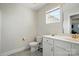 Bright bathroom featuring white cabinets, a toilet and a window at 4321 Hornyak Dr, Monroe, NC 28110
